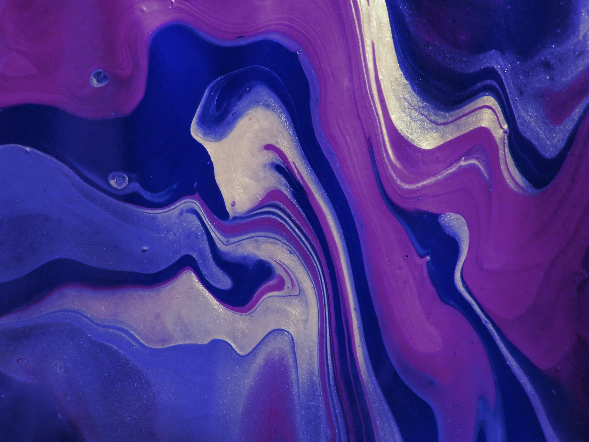 Abstract purple and blue fluid wave patterns; the organic curves that SVG wave generators aim to replicate digitally